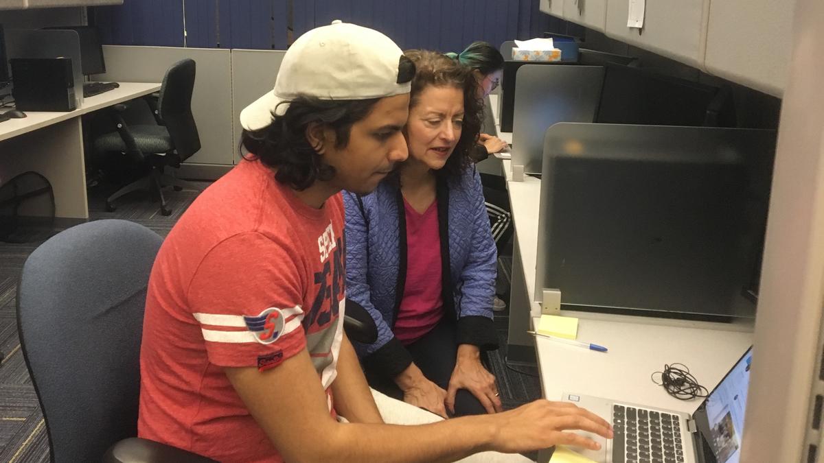 Photo of Anne and Adi using a computer